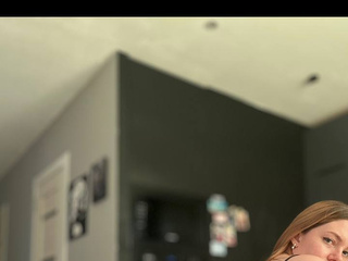 blonde in black lingerie shows off her charms