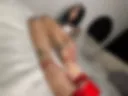 Feet with new pedicure in red heels
