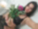 Black fishnet lingerie, stockings, flowers in hand
