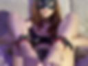A kitten in handcuffs on her legs