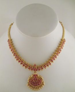 Golden necklace with a ruby